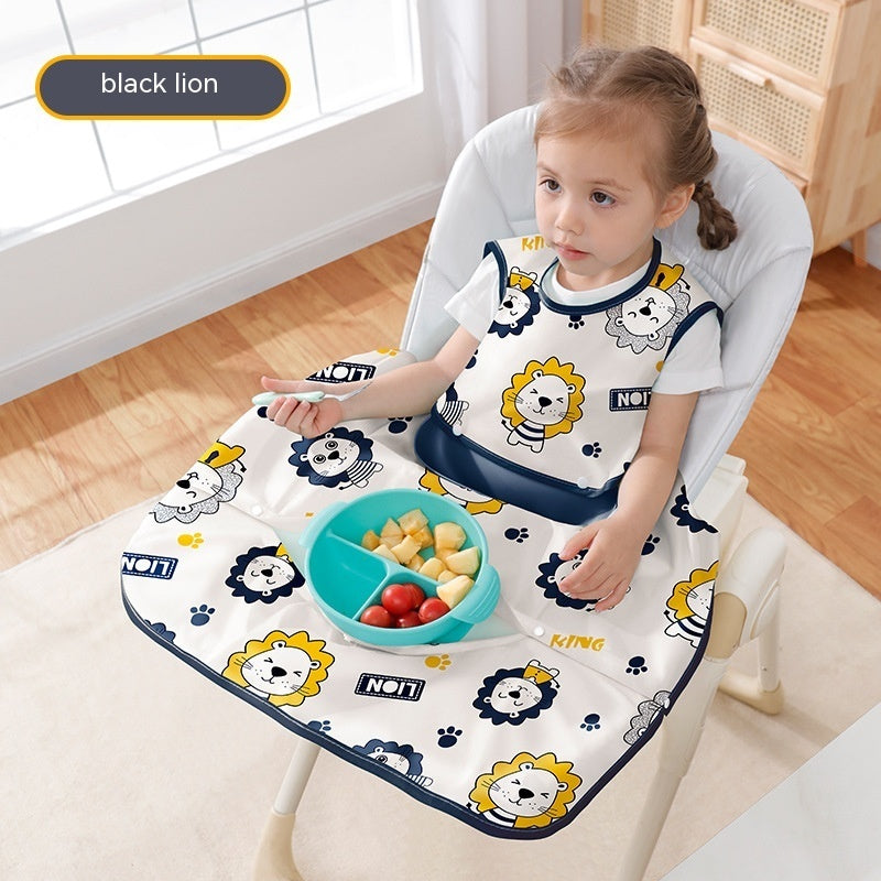 Child sitting in a high chair with a lion-themed bib and tray, eating fruits.