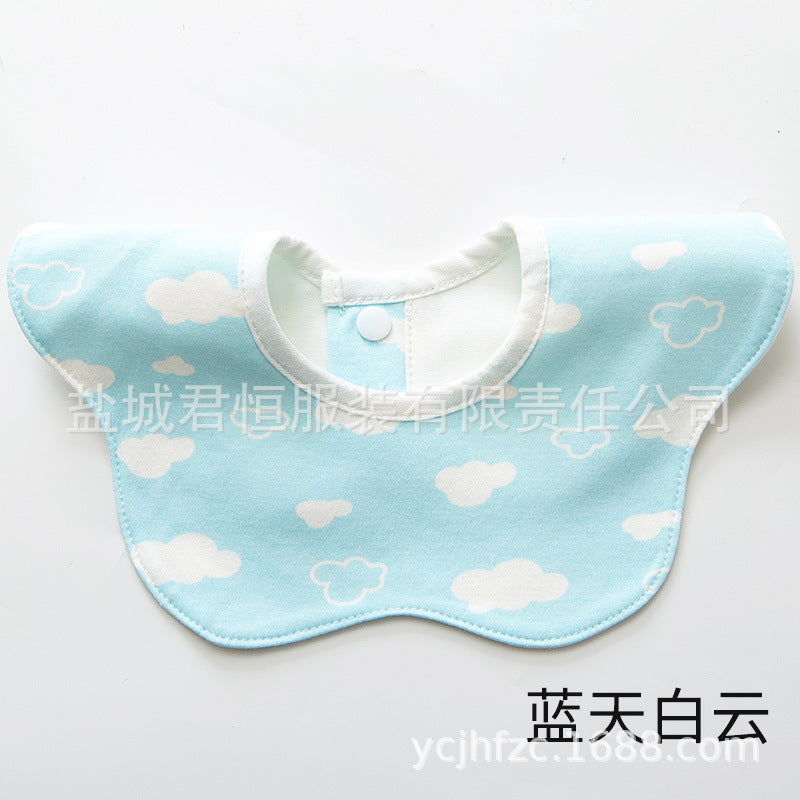 Baby bib with cloud pattern on a light blue background