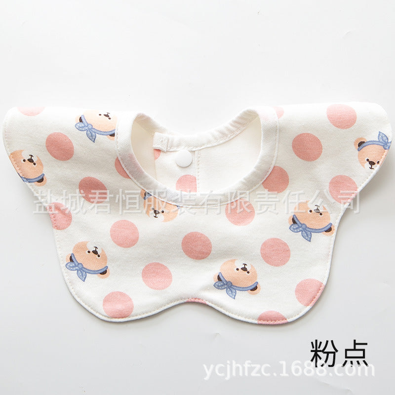 Baby bib with pink polka dots and cartoon characters on a white background
