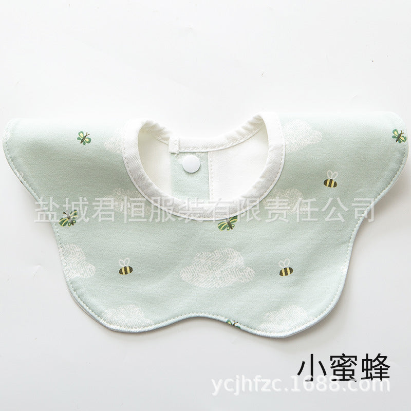 Green baby bib with bee pattern on a white background