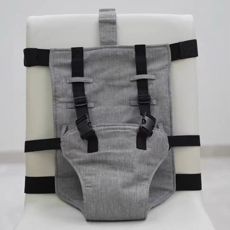 Gray dog harness with black straps on a white background