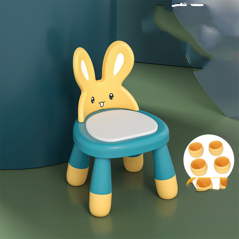 Children's chair with bunny design on a green surface