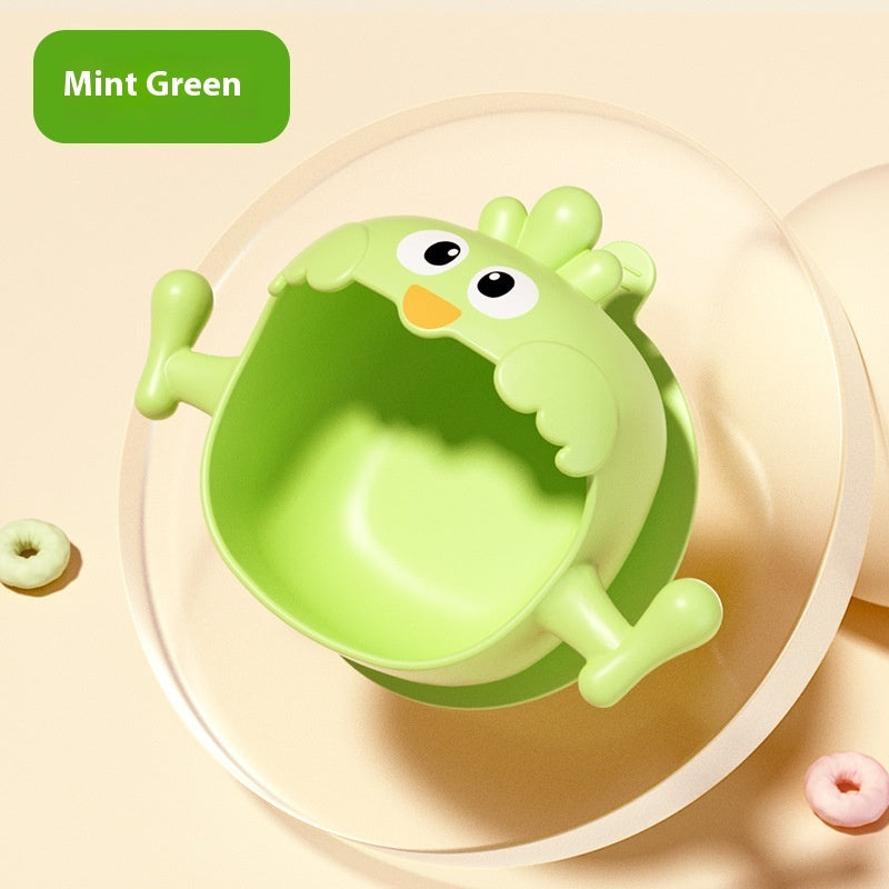 Green children's bowl with cartoon face on a beige background