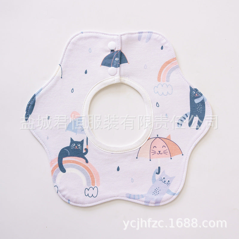 Baby bib with cartoon cat and rainbow design on a light background