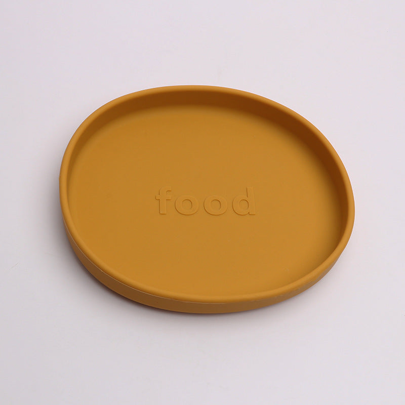 Mustard yellow plate with 'food' text on a white background