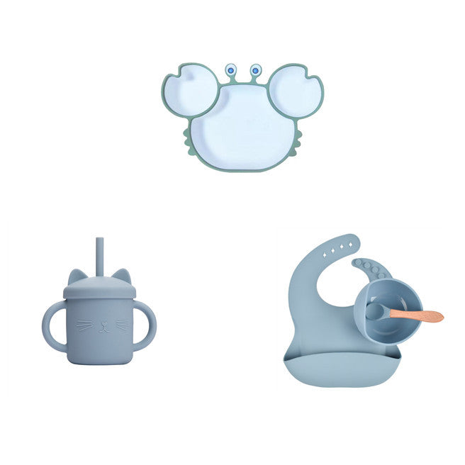 Set of blue silicone products including a sippy cup, straw, and lid on a white background