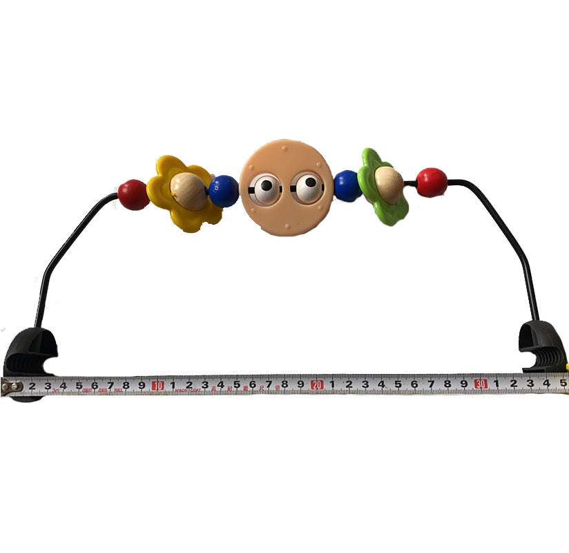 Colorful baby teething toy with a measuring tape below on a white background
