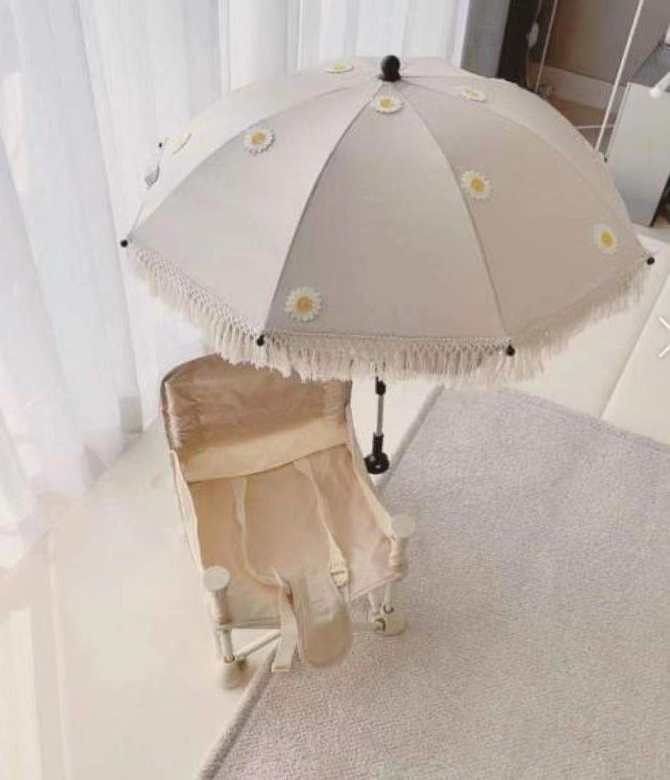 Beige umbrella with floral decorations on a white background