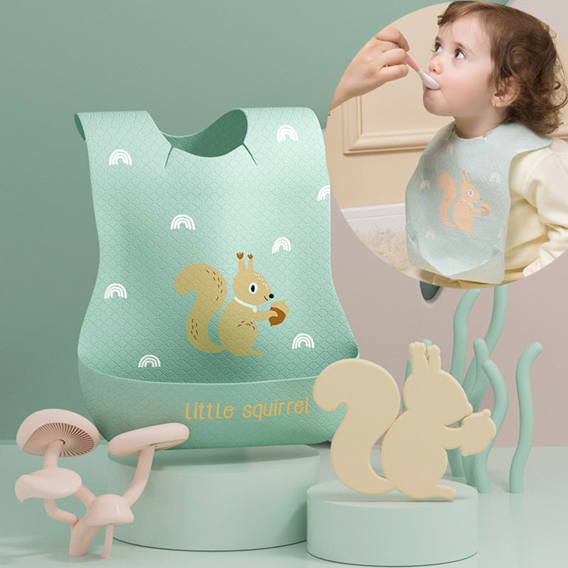 Children's bib with squirrel design, wooden toy, and child eating with a spoon.