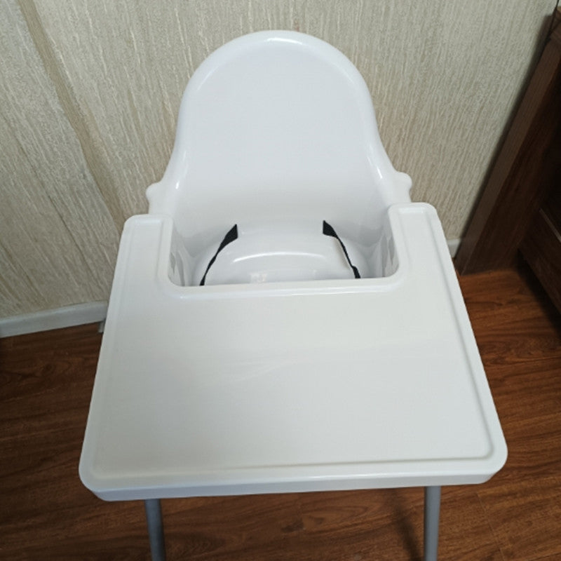 White baby high chair on a wooden floor with a neutral wall background
