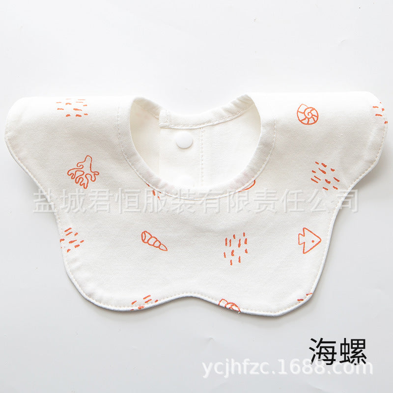 White baby bib with orange patterns on a white background