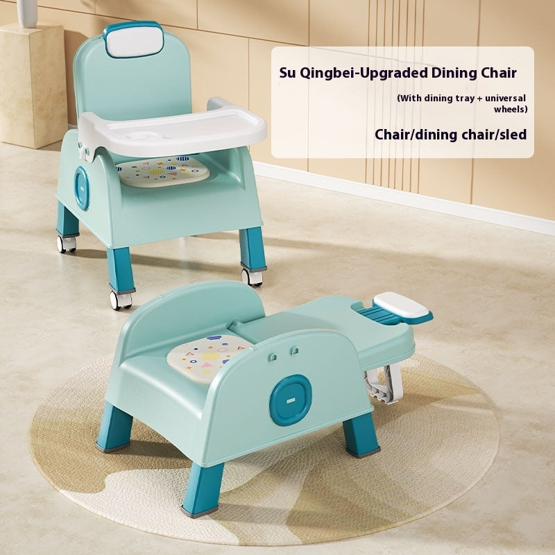 Children's dining chair with tray and wheels on a wooden floor.
