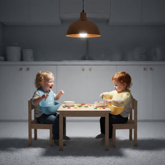 White kitchen, two toddlers in bibs playing, night.