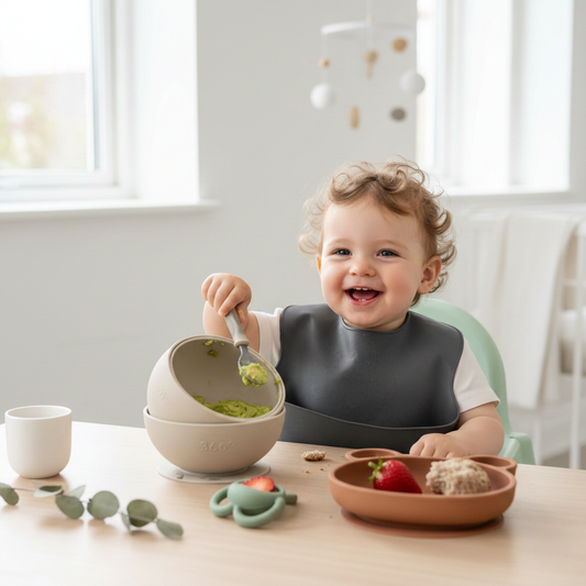 Happy baby eating with gender-neutral feeding essentials.