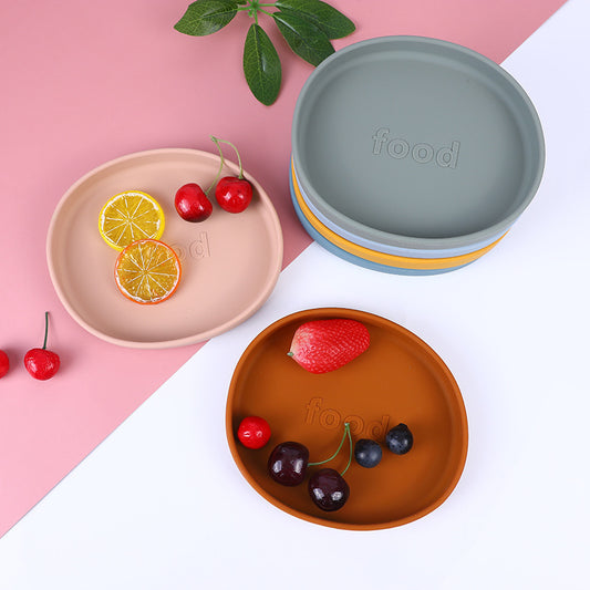 Colorful plates with fruits on a pink and white background