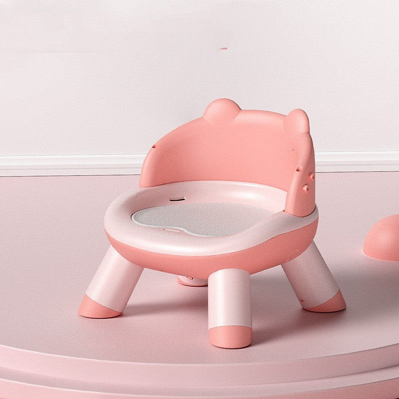 Pink children's chair with a white seat on a light pink background