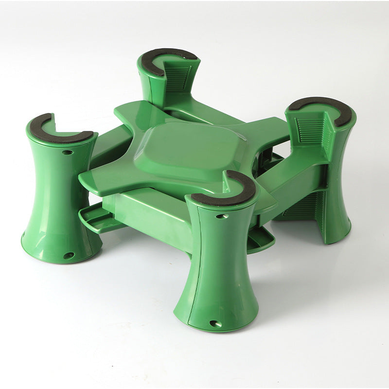 Green and black plastic component on a white background
