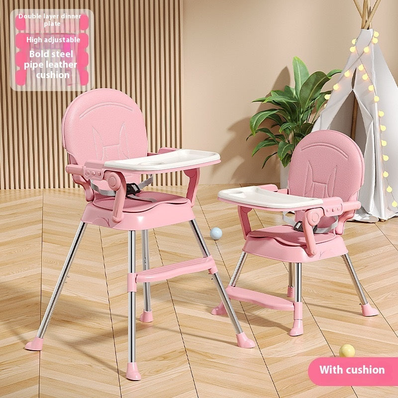 Pink high chairs with tray on a wooden floor, plant in the background