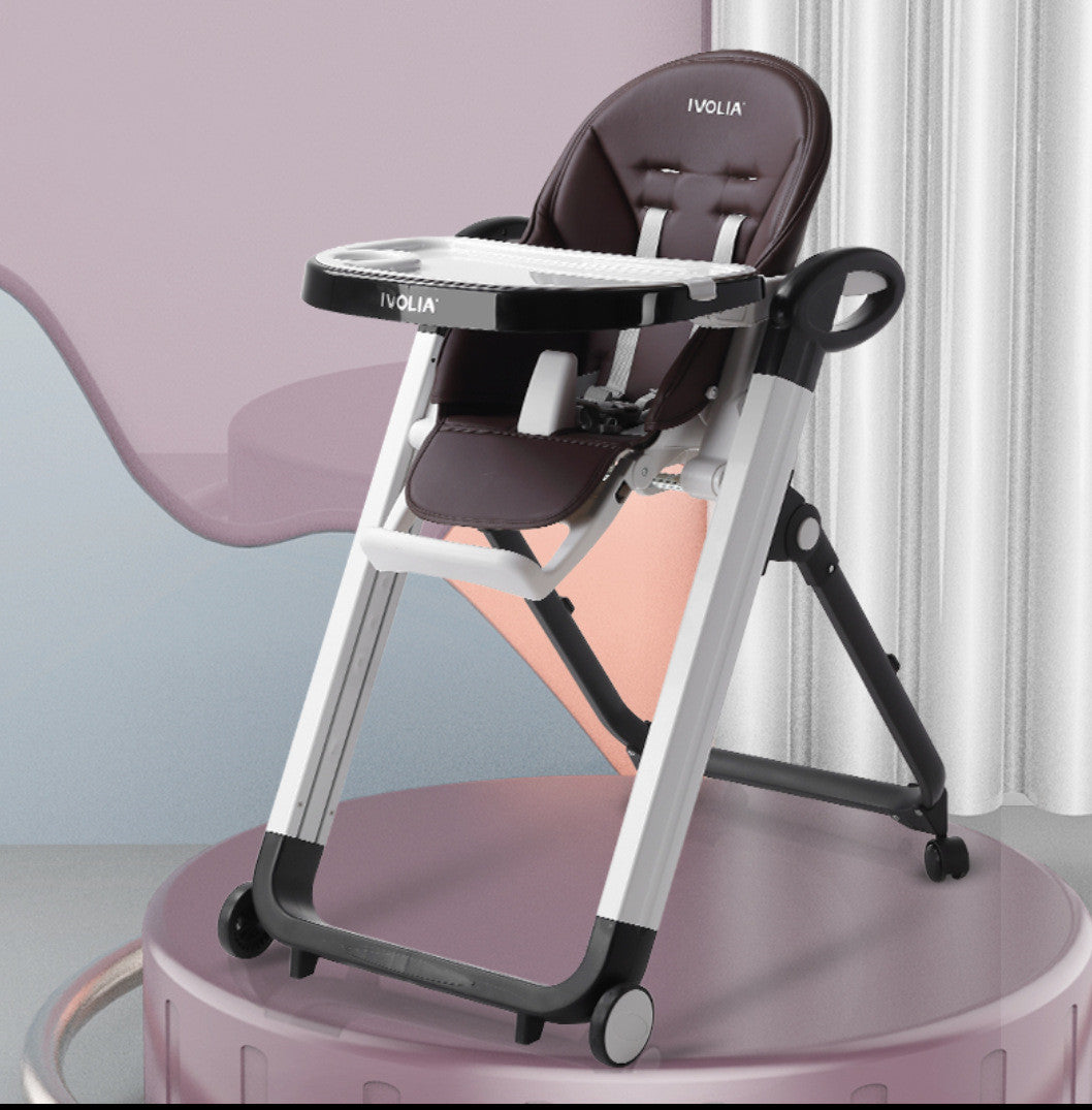 Baby high chair with 'IVOLIA' branding on a pink surface.