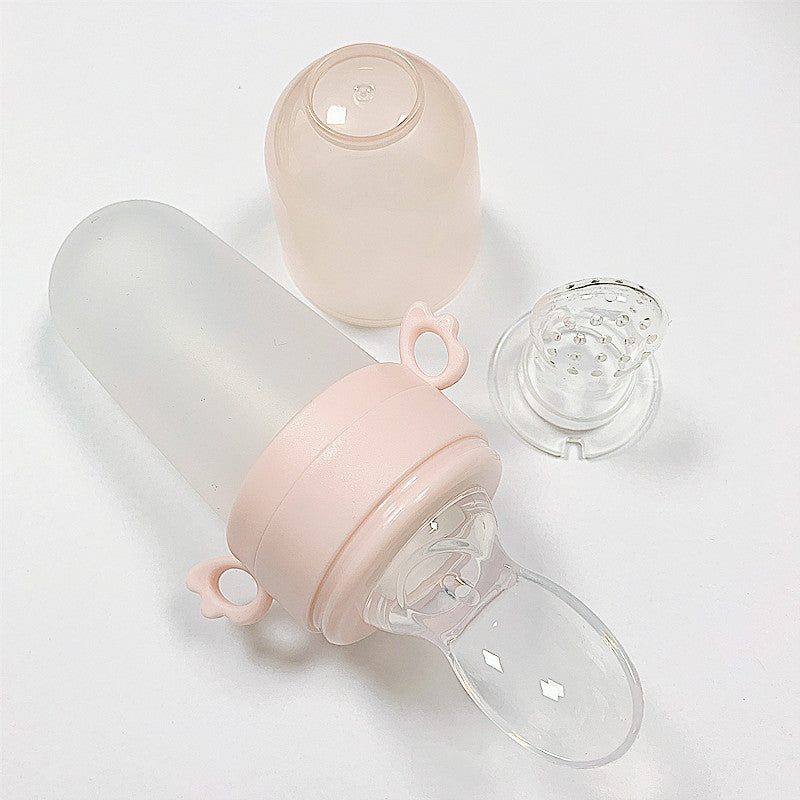 Baby bottle with pink cap and clear body on a white background