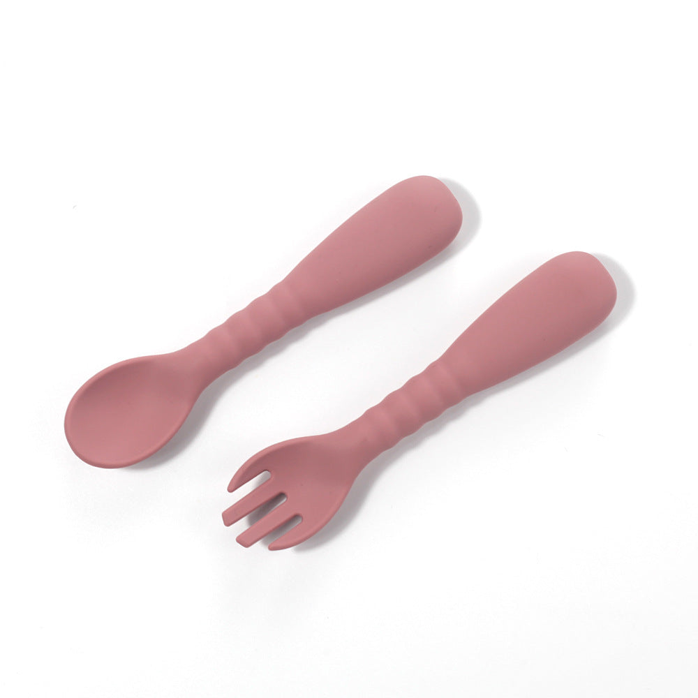 Pink spoon and fork set on a white background