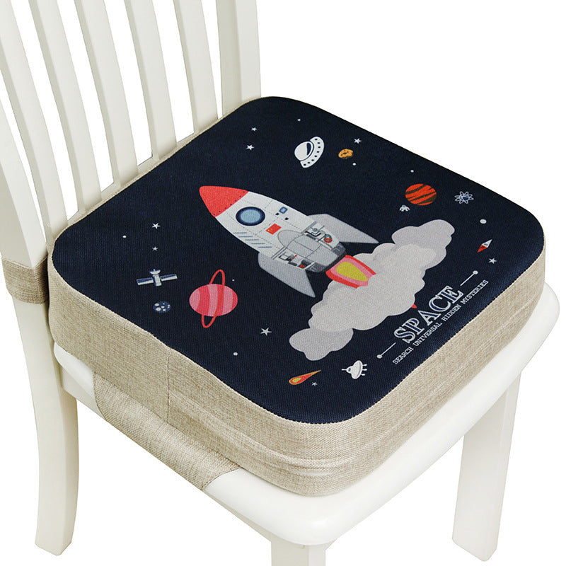 Space-themed chair pad with a rocket design on a white chair