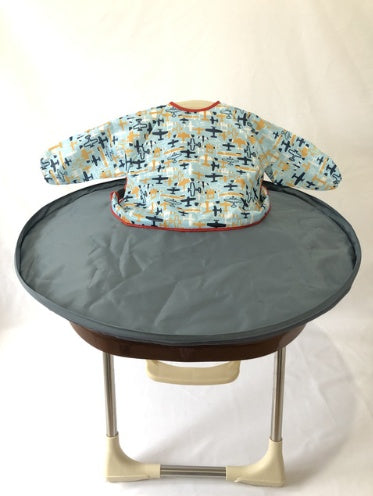 Children's bib on a stand with a plain background