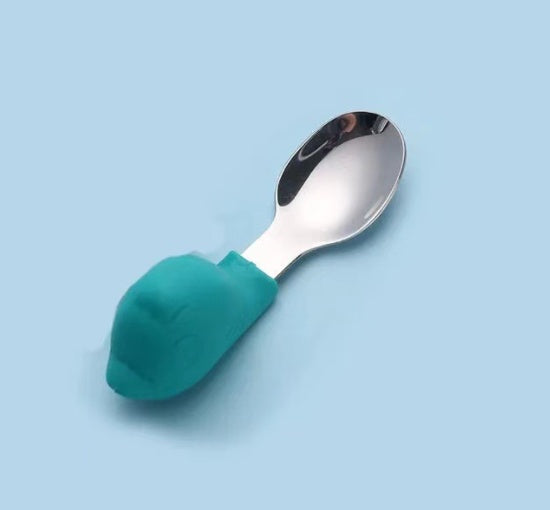 Spoon with a teal handle on a light blue background