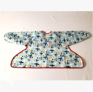 Baby bib with airplane pattern on a beige background
