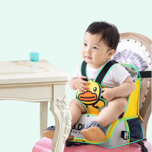 Child wearing a yellow duck-themed safety seat booster on a light blue background
