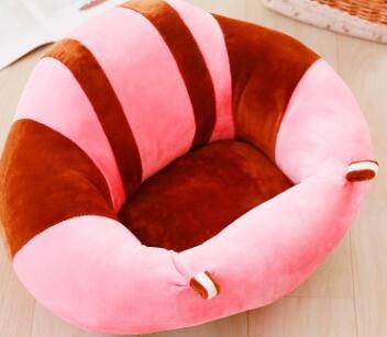 Pink and brown striped pet bed on a wooden floor