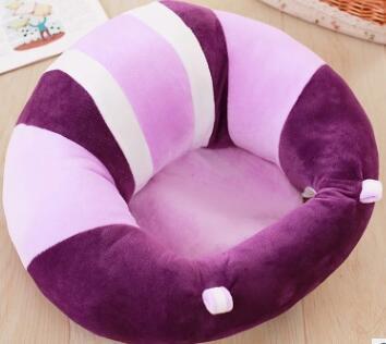 Round pet bed with purple and pink striped design on a wooden floor.
