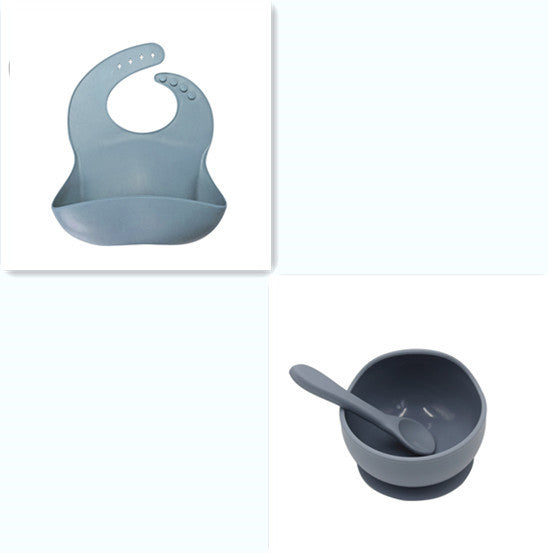 Set of baby feeding items including a bib, bowl, and spoon on a white background
