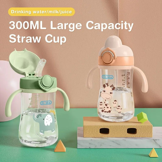 Two children's sippy cups with different designs on a green surface.