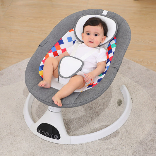 Baby in a gray baby swing with colorful seat on a wooden floor.