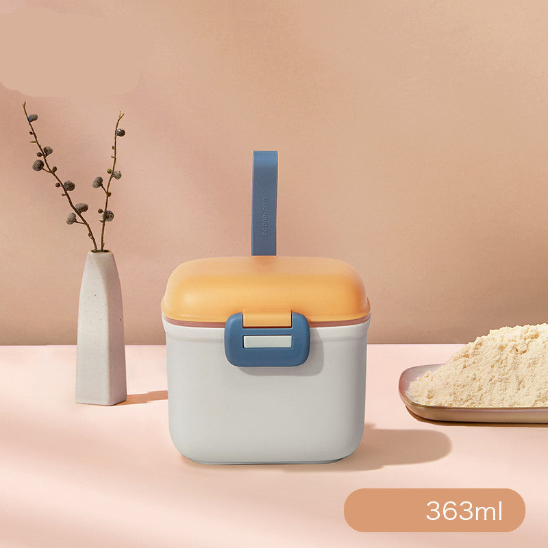 Container with a blue handle and orange lid on a pink background