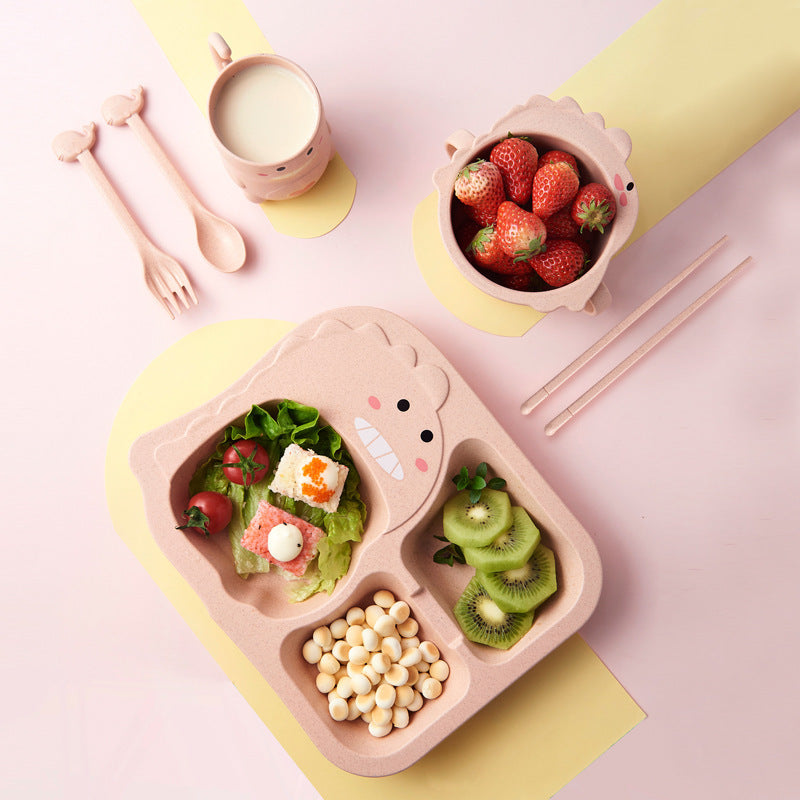 Children's lunchbox with compartments filled with food, a cup of milk, and a bowl of strawberries on a pink background.