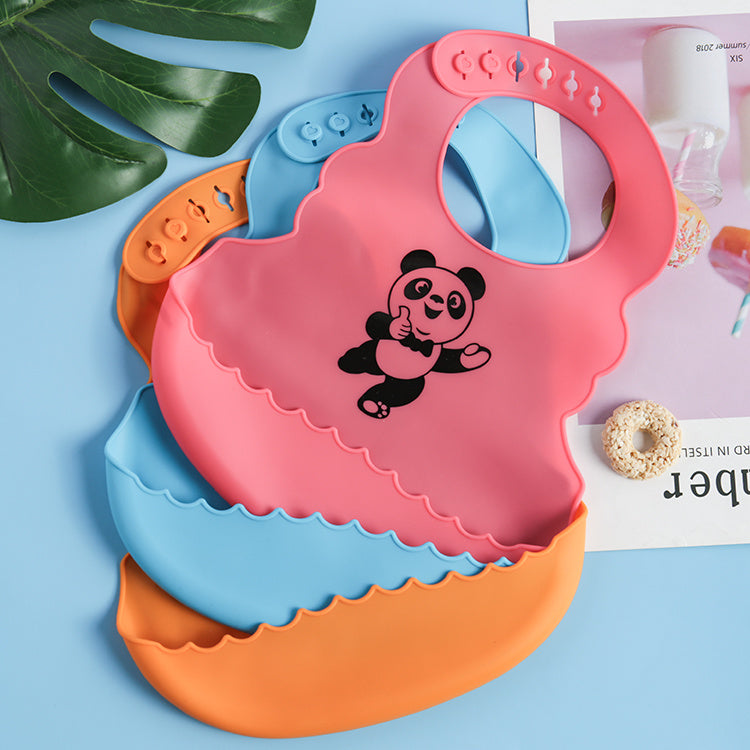Colorful silicone bibs with a panda design on a blue background