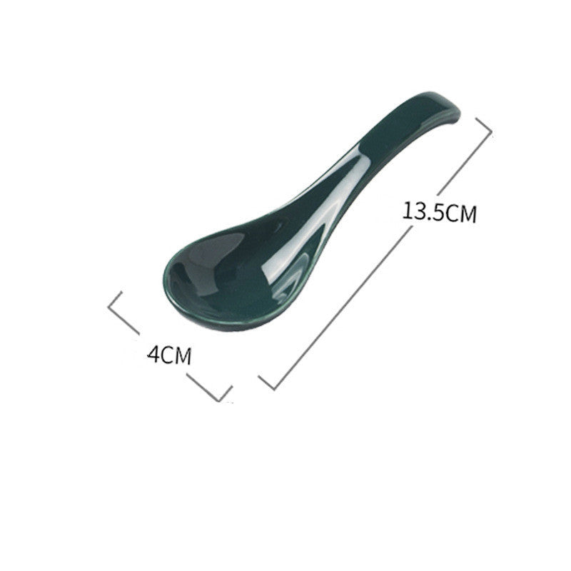 Green ceramic spoon with measurements on a white background