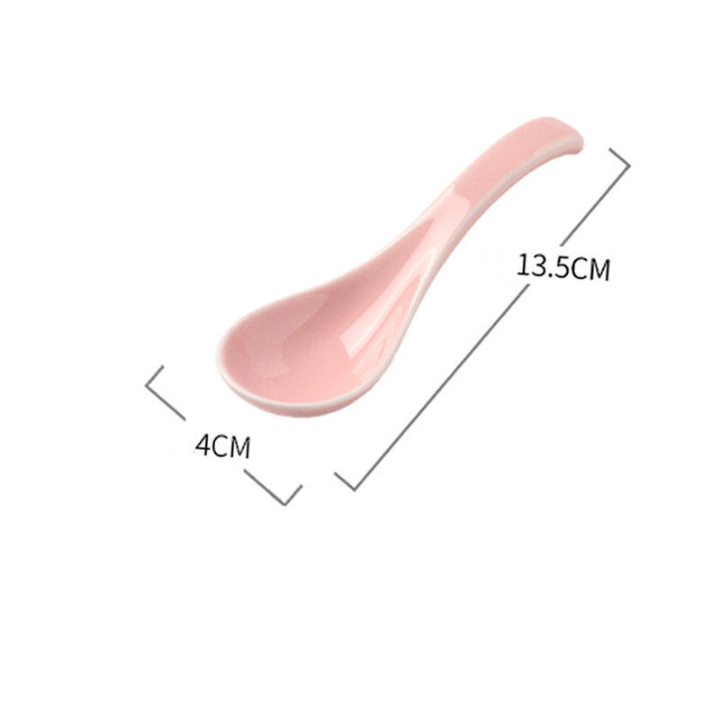 Pink ceramic spoon with measurements on a white background