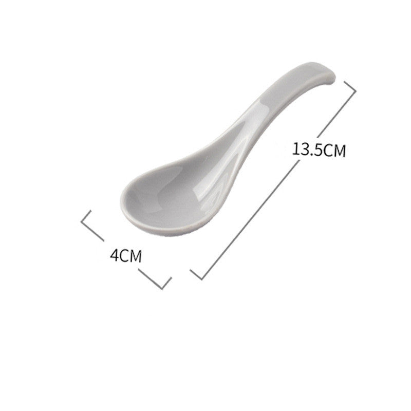 White ceramic spoon with measurements on a white background