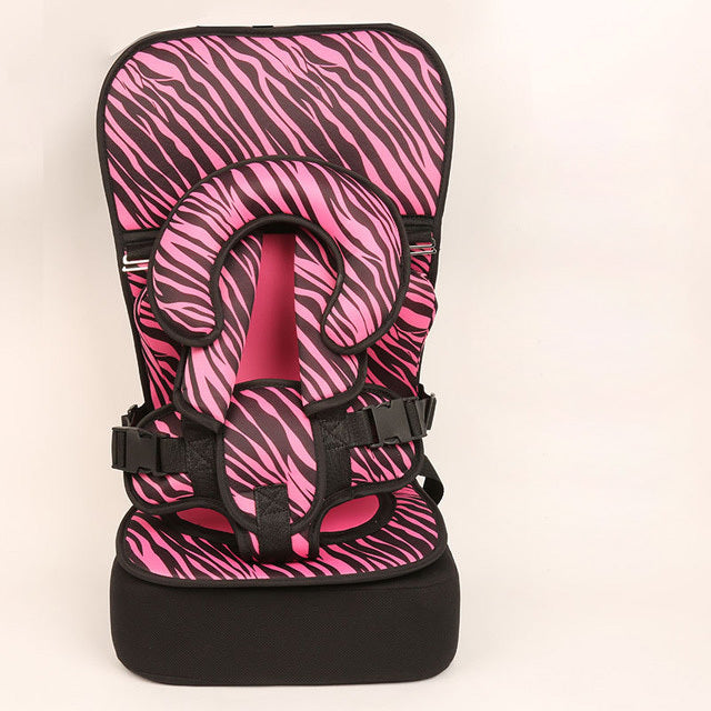 Pink and black zebra-patterned child safety seat on a beige background