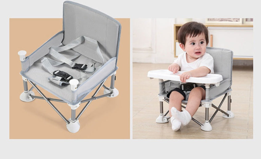 Portable baby seat with tray on a beige background and a child using it indoors.