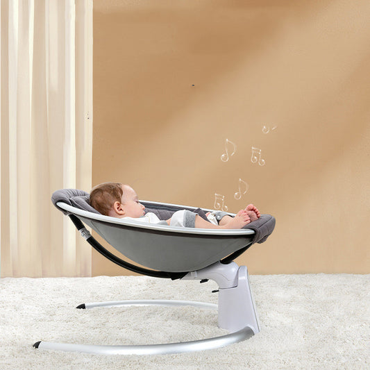 Baby in a gray baby swing with musical notes on a beige background