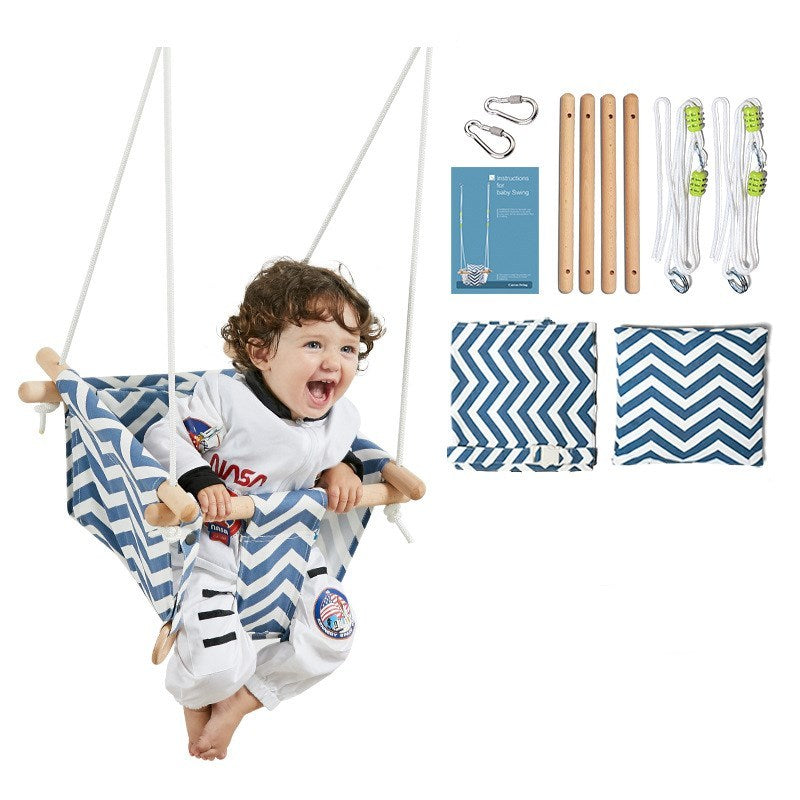 Child in a blue and white striped hammock with accessories on a white background