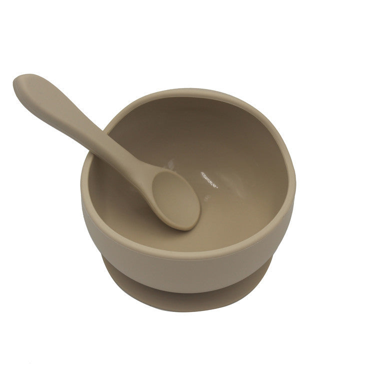 Beige bowl and spoon set on a white background