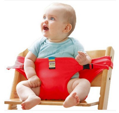 Baby sitting on a wooden chair with a red seat cover