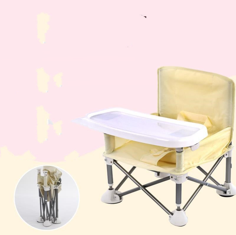 Yellow baby chair with a tray on a light pink background