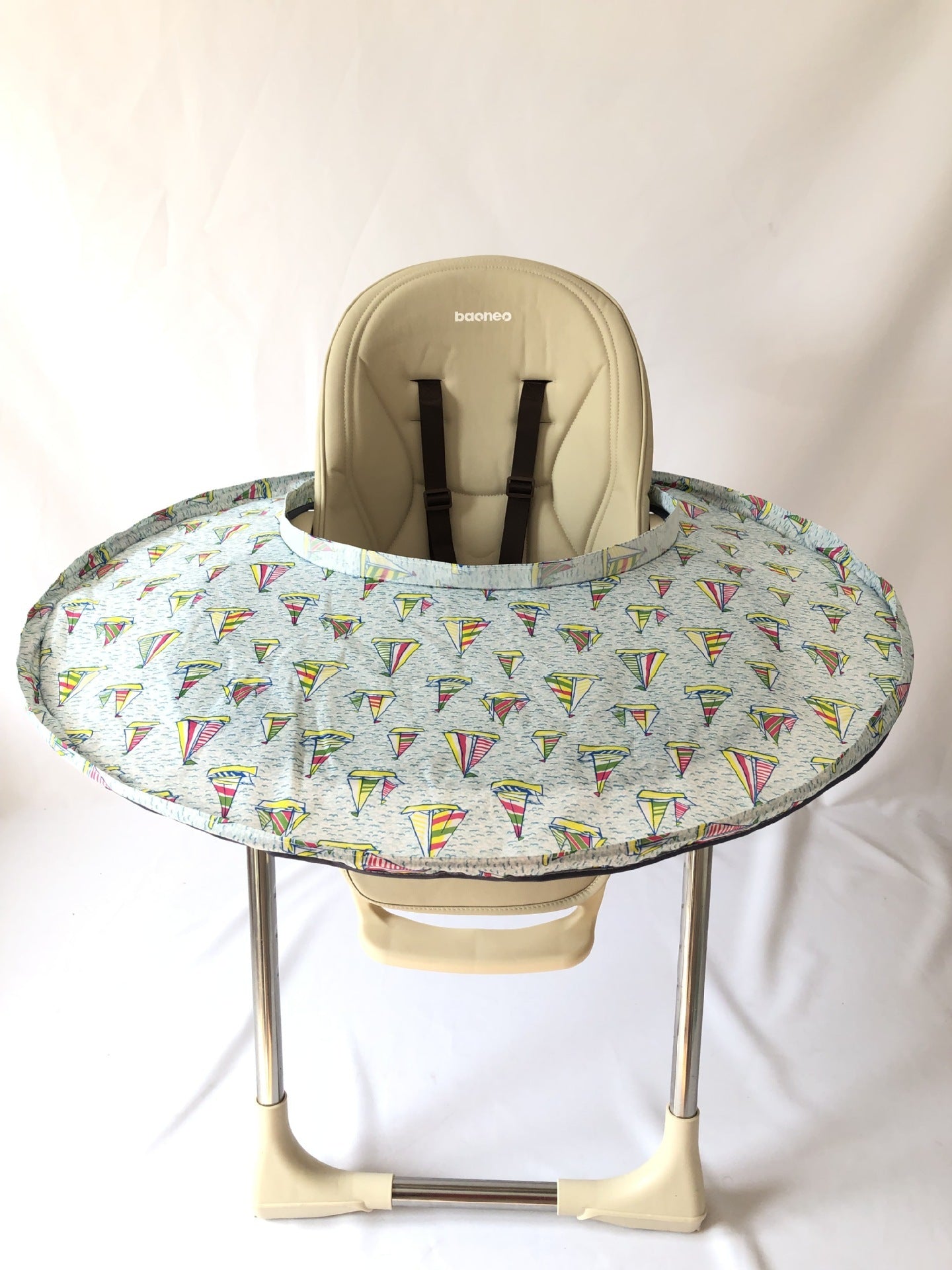Baby high chair with a colorful tray on a white background