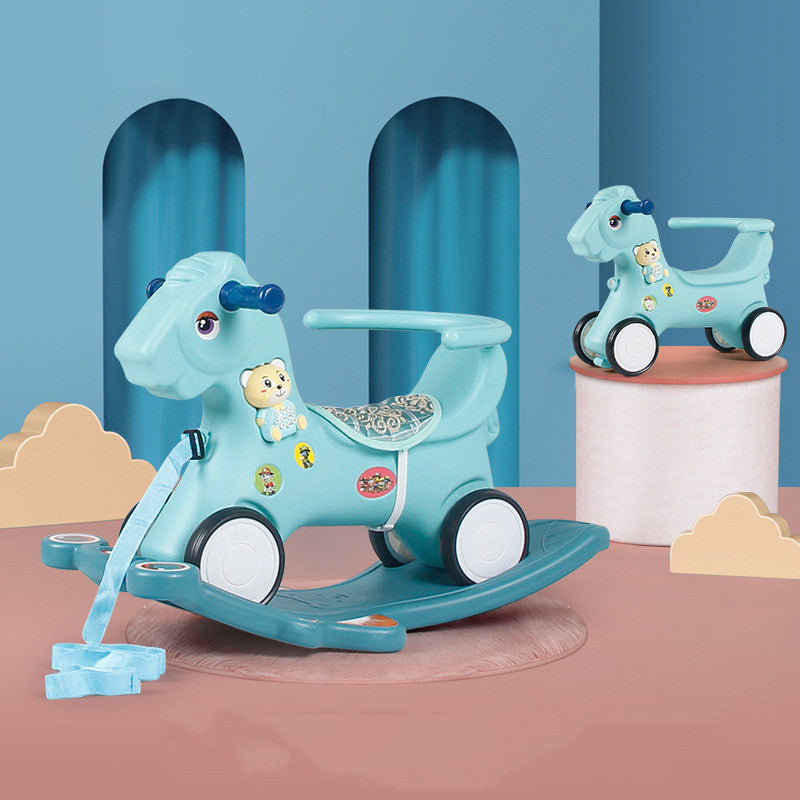 Blue rocking horse toy with teddy bear design on a pink platform against a blue background